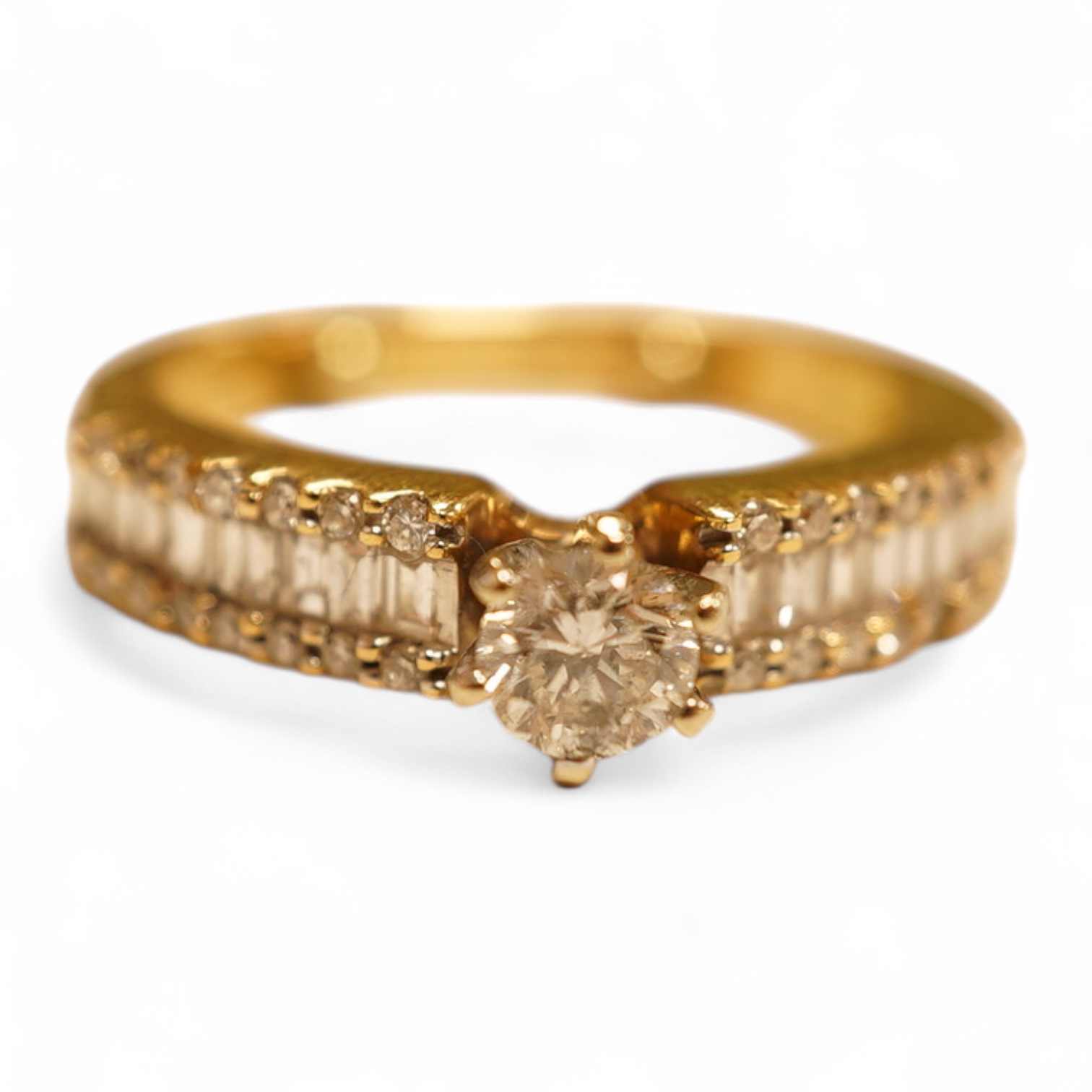A modern yellow metal and single stone diamond set ring, with baguette and round cut diamond cluster set shoulders, total diamond weight approx. 0.50ct, size J/K (sizing spheres), gross weight 4.6 grams.